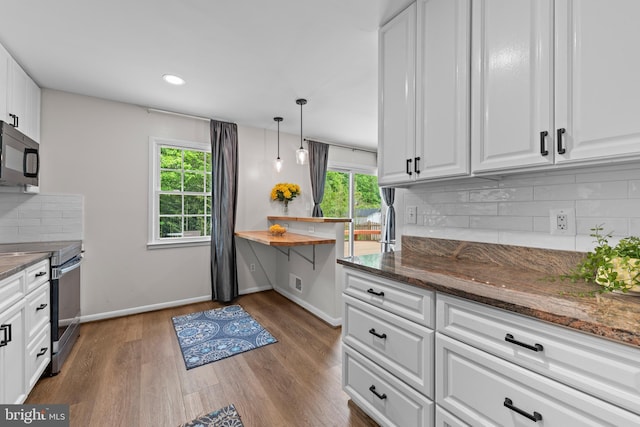 9518 Center St, Vienna, VA 22181 - kitchen with stainless steel electric range, black microwave, white cabinets, and recessed lighting