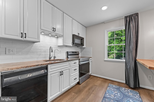 9518 Center St, Vienna, VA 22181 - kitchen featuring black appliances, a sink, white cabinets, backsplash, and recessed lighting