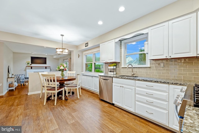kitchen with dishwasher, a sink, white cabinetry, light wood-type flooring, and light stone countertops