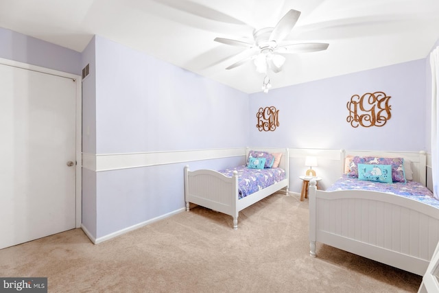 carpeted bedroom featuring a ceiling fan and baseboards