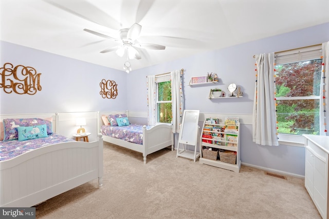 bedroom with carpet, ceiling fan, and baseboards
