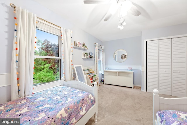 carpeted bedroom with a closet and a ceiling fan
