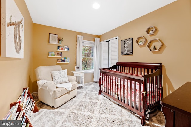 bedroom with a closet and baseboards