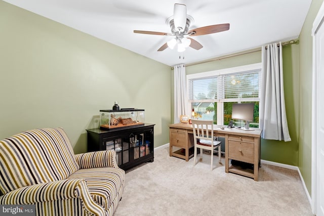 office area with light colored carpet, ceiling fan, and baseboards