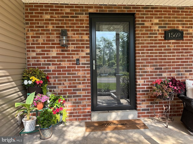 property entrance featuring brick siding