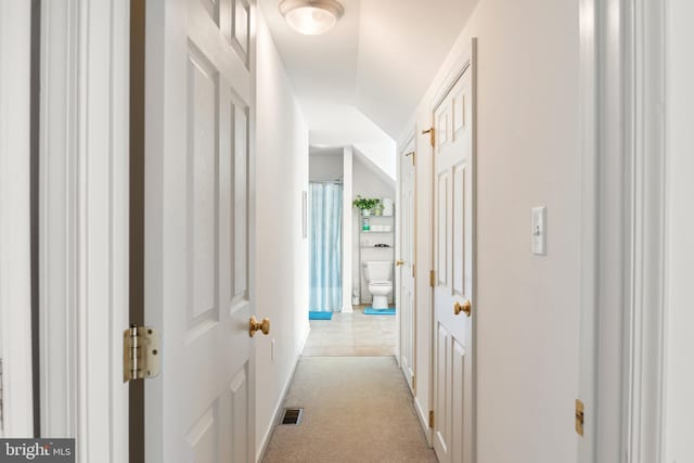 corridor featuring light carpet and visible vents