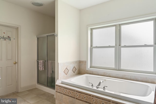 full bathroom with a bath, plenty of natural light, tile patterned flooring, and a shower stall