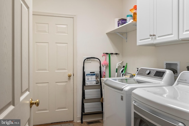 laundry area with separate washer and dryer, cabinet space, and visible vents