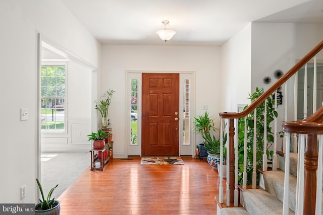 entrance foyer with stairs and hardwood / wood-style floors