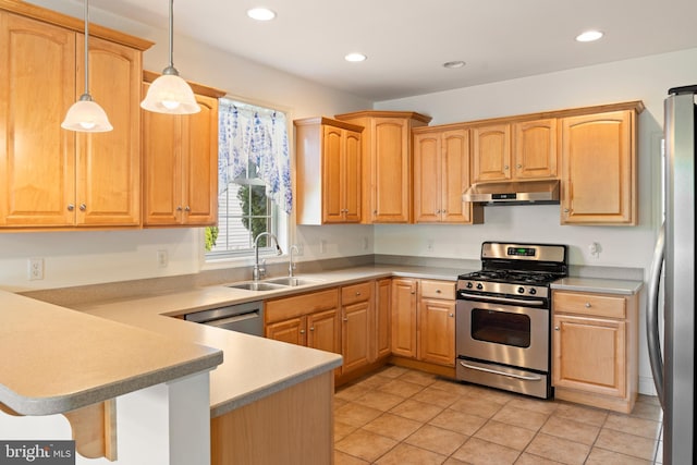kitchen featuring hanging light fixtures, a peninsula, a sink, under cabinet range hood, and appliances with stainless steel finishes
