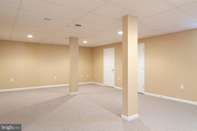 finished basement featuring a paneled ceiling, carpet, and recessed lighting