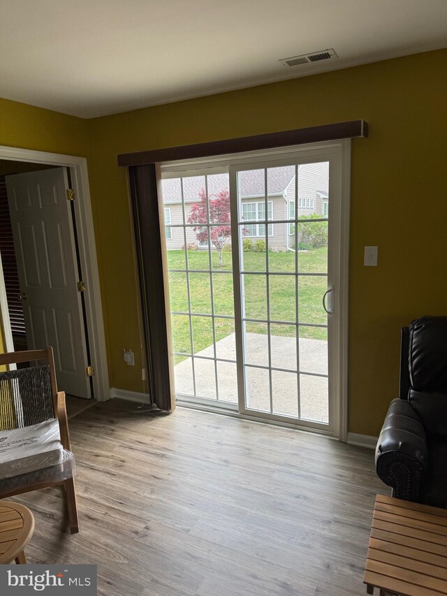 entryway featuring baseboards, a healthy amount of sunlight, and visible vents