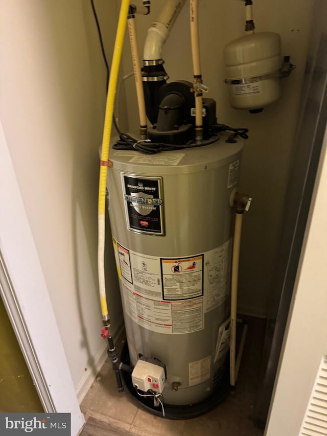 utility room featuring gas water heater
