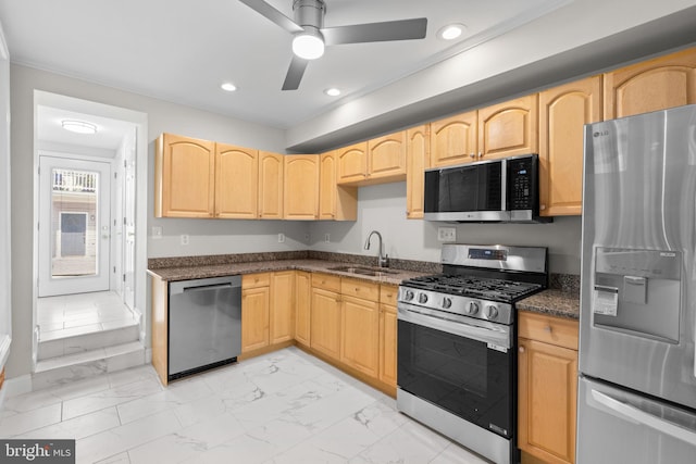 722 S Clinton St, Baltimore, MD 21224 - kitchen with appliances with stainless steel finishes, a sink, light marble finish floors, light brown cabinets, and a ceiling fan