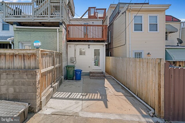 722 S Clinton St, Baltimore, MD 21224 - rear view of property featuring a balcony, entry steps, and a fenced backyard