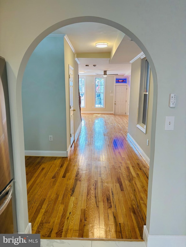 722 S Clinton St, Baltimore, MD 21224 - hall featuring hardwood / wood-style floors, crown molding, baseboards, and arched walkways