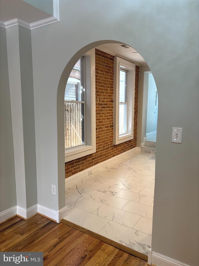 722 S Clinton St, Baltimore, MD 21224 - bonus room featuring baseboards, arched walkways, and marble finish floors