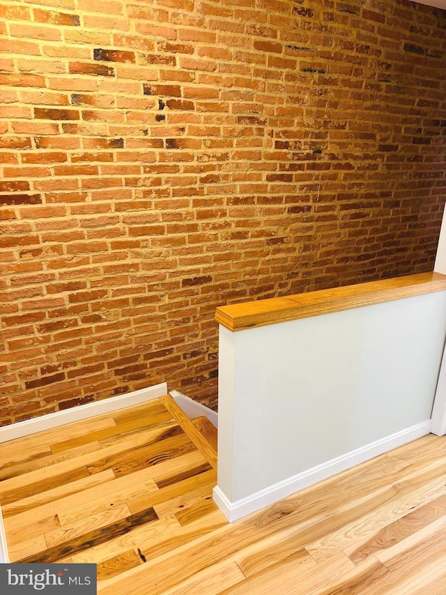 722 S Clinton St, Baltimore, MD 21224 - detailed view of wood finished floors and brick wall
