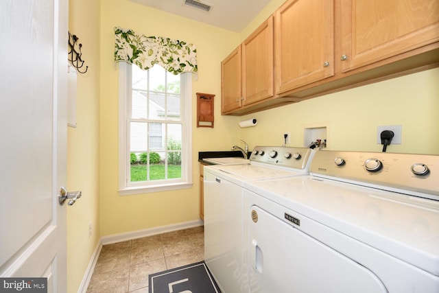 7400 Michael Ave, Easton, MD 21601 - washroom featuring cabinet space, washer and dryer, baseboards, and light tile patterned floors