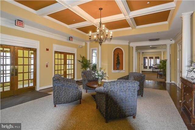 7400 Michael Ave, Easton, MD 21601 - living area featuring french doors, healthy amount of natural light, coffered ceiling, ornamental molding, and a chandelier