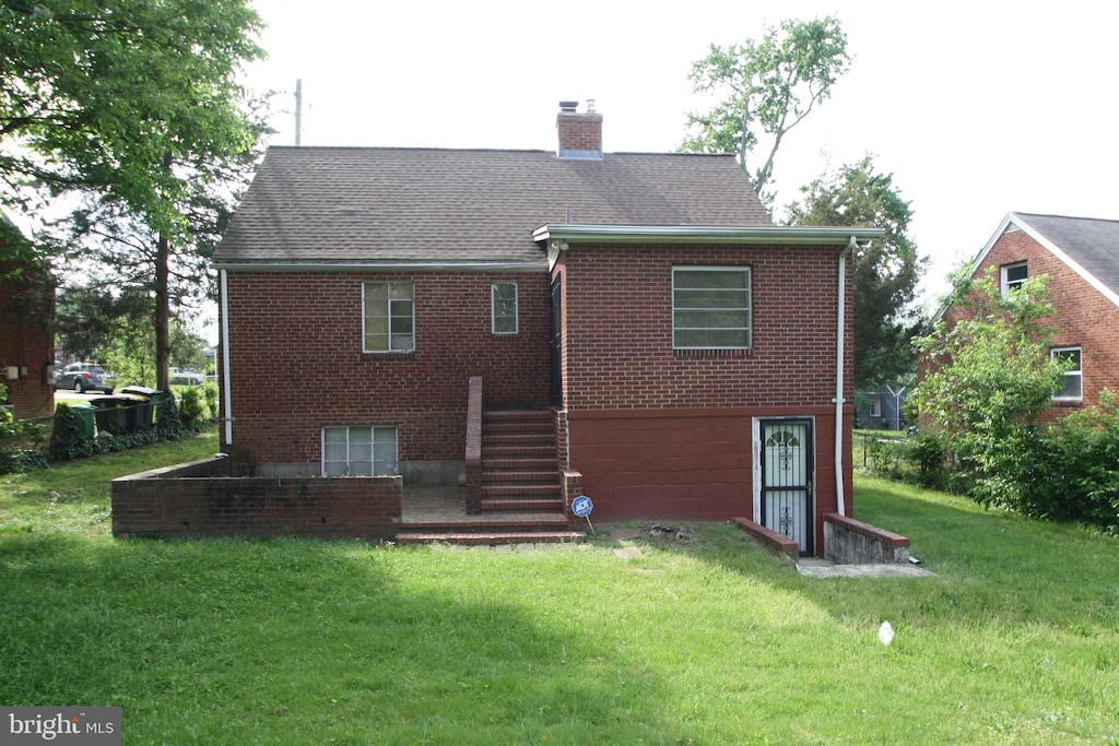 5205 58th Ave, Hyattsville, MD 20781 - back of property featuring a chimney, a yard, brick siding, and stairs