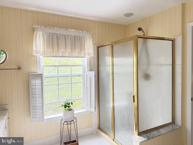 bathroom with wallpapered walls, visible vents, and a stall shower