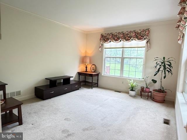 sitting room featuring visible vents, crown molding, and carpet floors