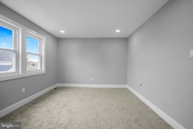carpeted empty room with baseboards and recessed lighting