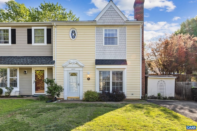 multi unit property featuring fence, a chimney, and a front yard