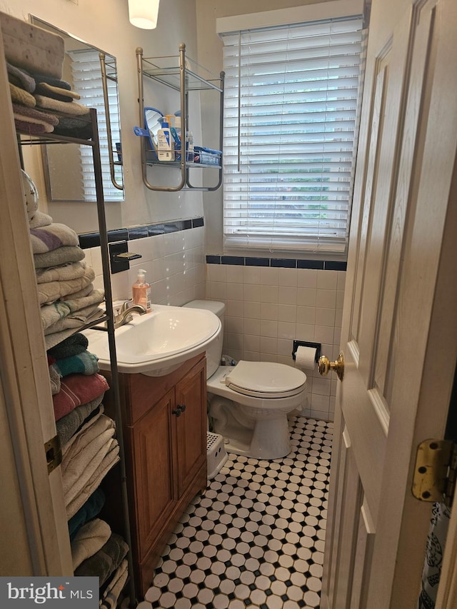 9 47th St SE, Washington, DC 20019 - half bath featuring vanity, tile walls, and tile patterned flooring