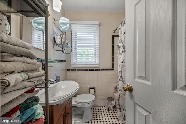 9 47th St SE, Washington, DC 20019 - bathroom with tile walls, vanity, tile patterned floors, and a shower with shower curtain