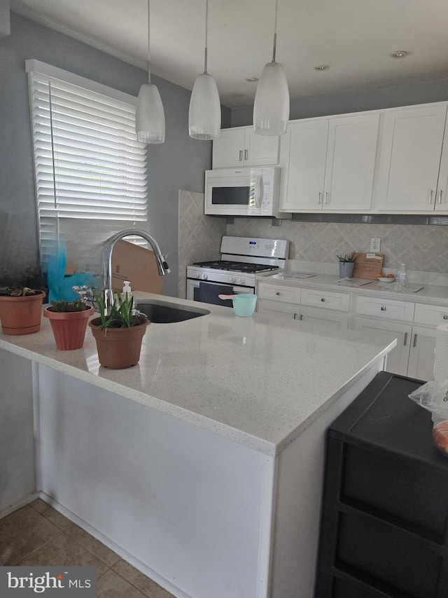 9 47th St SE, Washington, DC 20019 - kitchen featuring white appliances, tasteful backsplash, light stone counters, and white cabinetry