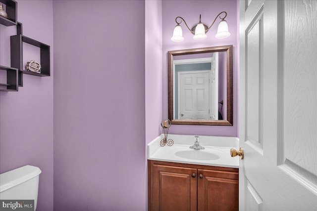 bathroom featuring vanity and toilet