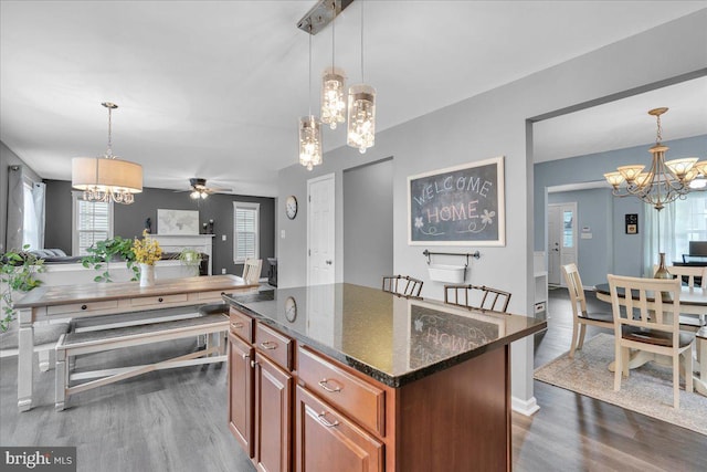 kitchen featuring dark stone counters, plenty of natural light, open floor plan, and dark wood-style floors