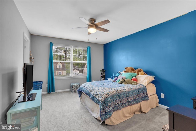 bedroom with ceiling fan, carpet flooring, and baseboards