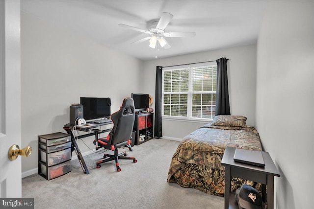 carpeted bedroom with baseboards and a ceiling fan