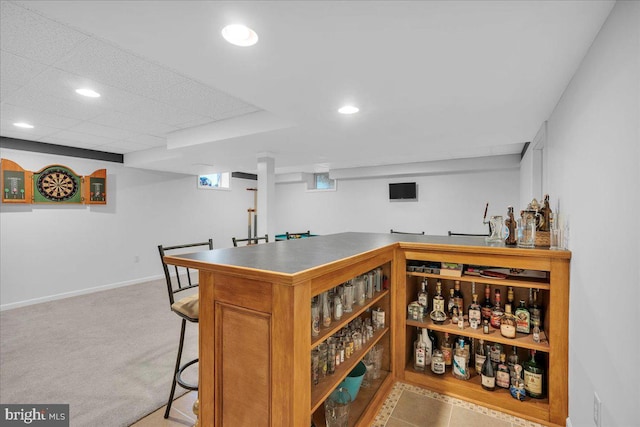 bar featuring a bar, baseboards, carpet floors, and recessed lighting
