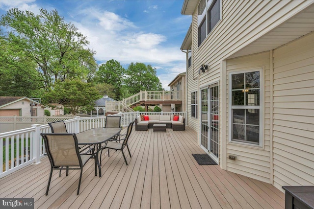 deck with outdoor dining space and outdoor lounge area
