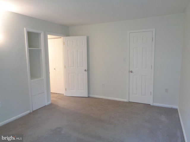 unfurnished bedroom featuring baseboards and carpet