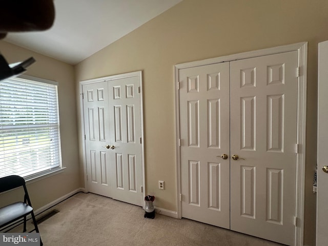 937 Dunloring Ct, Upper Marlboro, MD 20774 - unfurnished bedroom featuring vaulted ceiling, light carpet, multiple closets, and baseboards