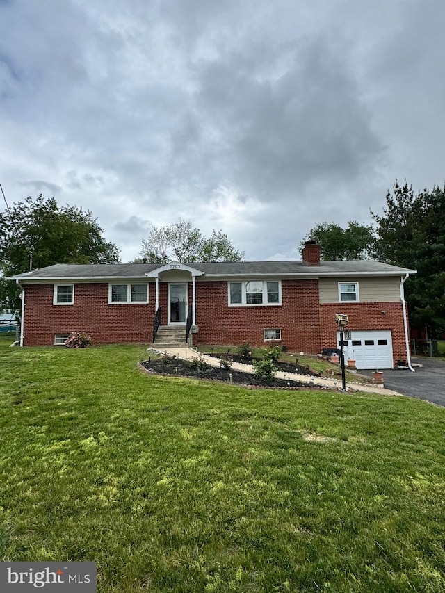ranch-style home with a chimney, brick siding, entry steps, aphalt driveway, and a front lawn