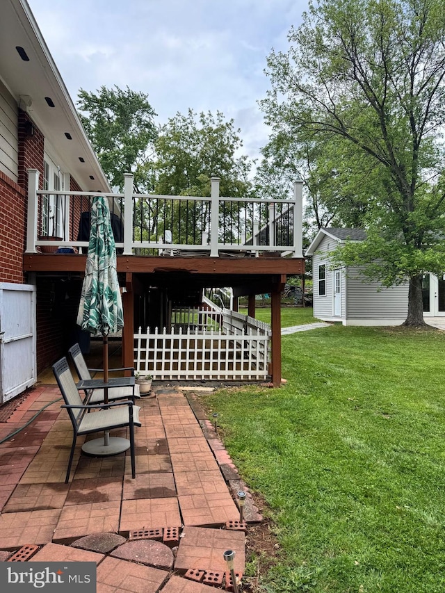 view of yard with stairs, an outbuilding, a patio, and a wooden deck