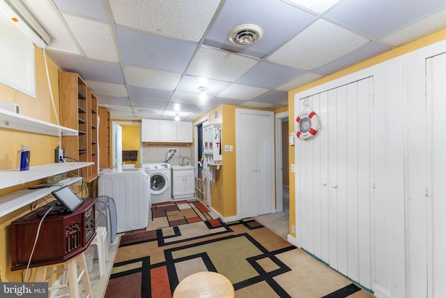 7703 Huron Dr, Gainesville, VA 20155 - washroom featuring washer / clothes dryer, cabinet space, and light floors