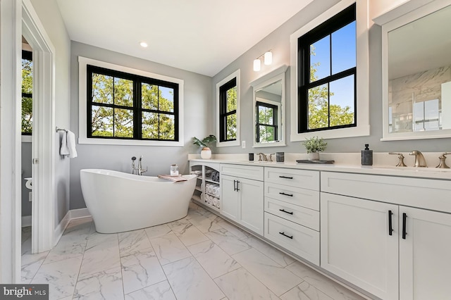 3015 Friends Rd, Annapolis, MD 21401 - full bathroom featuring marble look tile flooring, double vanity, a soaking tub, recessed lighting, and baseboards