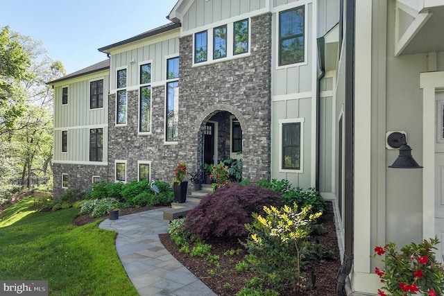 3015 Friends Rd, Annapolis, MD 21401 - view of front of house featuring board and batten siding, a front lawn, and stone siding