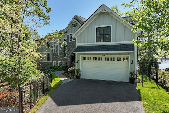 3015 Friends Rd, Annapolis, MD 21401 - view of front of house with board and batten siding, asphalt driveway, fence, an attached garage, and roof with shingles