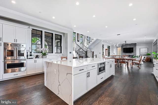 3015 Friends Rd, Annapolis, MD 21401 - kitchen with double oven, ornamental molding, open floor plan, a spacious island, and recessed lighting