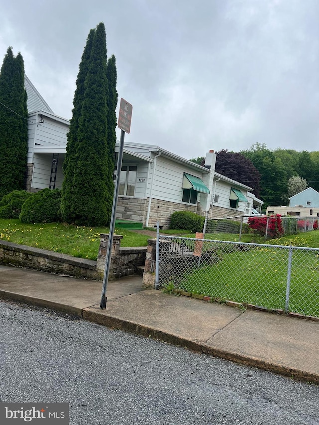 1228 Spruce St, Ashland, PA 17921 - view of front of house with fence, stone siding, and a front yard