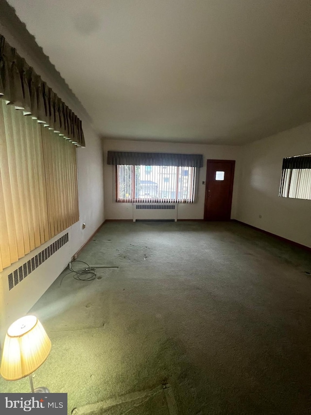 1228 Spruce St, Ashland, PA 17921 - unfurnished living room with radiator, carpet flooring, and baseboards