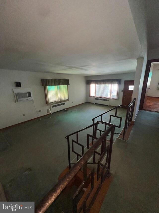 1228 Spruce St, Ashland, PA 17921 - interior space featuring an AC wall unit, carpet, and radiator heating unit